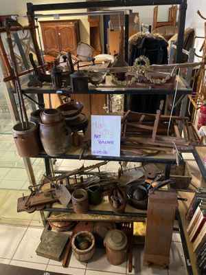 a display of antique items on a shelf in a room