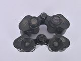 four pairs of binoculars that are sitting on a white surface
