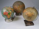 three globes sitting on top of each other on a table