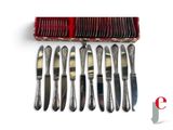 a lot of forks and knives in a red box