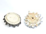 two pieces of pottery sitting on a white surface