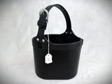 a small black bucket with a tag on it