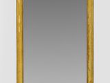 an image of a mirror with a gold frame on a white wall