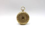 an image of a gold pocket watch sitting on a white surface