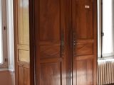 an image of a living room with a large wooden armoire