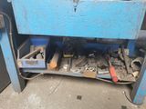 a blue work bench with tools on it in a garage