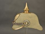 a helmet with a gold decoration on top of it