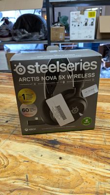 a box on the table with a remote and headphones in it