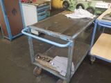 an image of a kitchen area with a table and a refrigerator