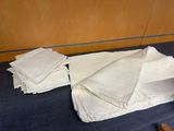 several folded napkins on a table with a knife and knife rest