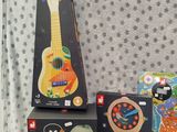 several children ' s musical instruments are on a table in front of a wallpaper