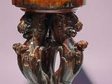 an image of a vase on a stand with two dogs on it