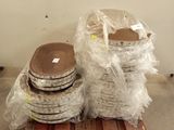 many stacks of plates on a pallet in a warehouse