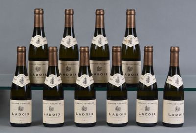 six bottles of wine are lined up in a row on a table