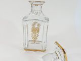 a small glass bottle with a gold lid and a small glass bottle with a gold lid