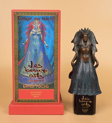 a statue of a woman holding a bottle of wine next to a box of wine