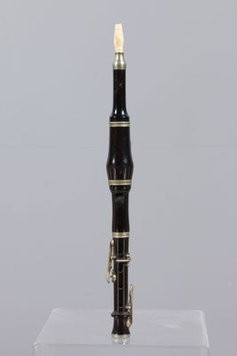 a black and gold pen sitting on top of a clear box