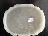 a white bowl with a sticker on it sitting on a table