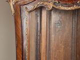 a large wooden cabinet with a mirror on top of it