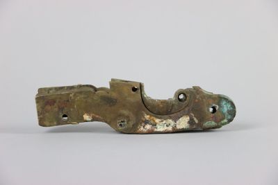 a metal object that looks like a shoe on a white surface