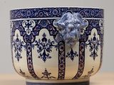 a blue and white bowl with a lion head on it