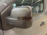 a side view mirror of a car with a sticker on it
