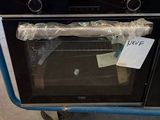 a blue cart with a black oven on top of it