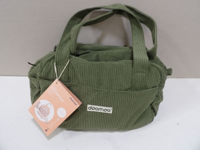 a green bag with a tag on it sitting on a table
