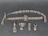 an image of a necklace, bracelet and earring set on a table