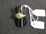 a ring with a green stone on it and a price tag