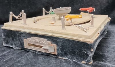 a toy model of a fishing boat on a box