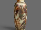 an image of a vase with a painting on it on a gray surface