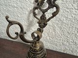 a small metal candle holder on a wooden table