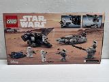 two lego star wars vehicles are sitting on a white surface