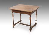 an old wooden table with turned legs and a wooden top