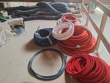 many different types of hoses laid out on the floor