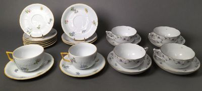 many cups and saucers that are sitting on the table