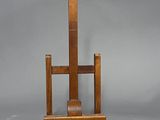 a wooden easel with a roll of toilet paper on it