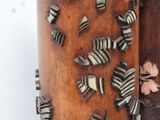 a lot of zebras that are on the side of a wooden pole