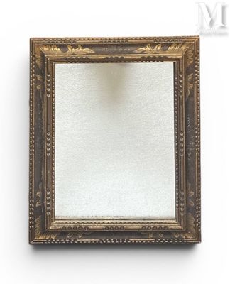 an antique gold framed mirror with a white background