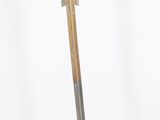 sculpture of a wooden arrow on a metal base on a white background