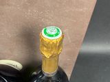 two bottles of wine sitting next to each other
