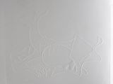 someone is drawing a deer on a piece of paper on a table