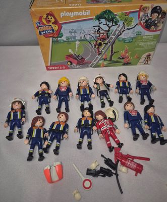 a box of playmobil with a bunch of people in it
