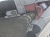 a reflection of a person in the rear view mirror of a car