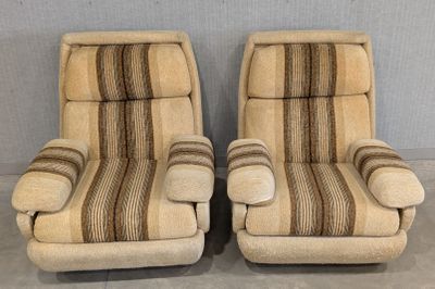 pair of mid century style lounge chairs with striped upholstered cushions
