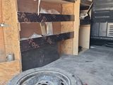 a truck with a tire inside of it in a garage