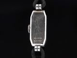 a silver watch with a black face on a black background