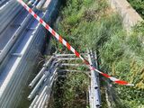 a pile of metal pipes on the side of the road