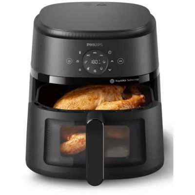 a black air fryer with a chicken inside of it